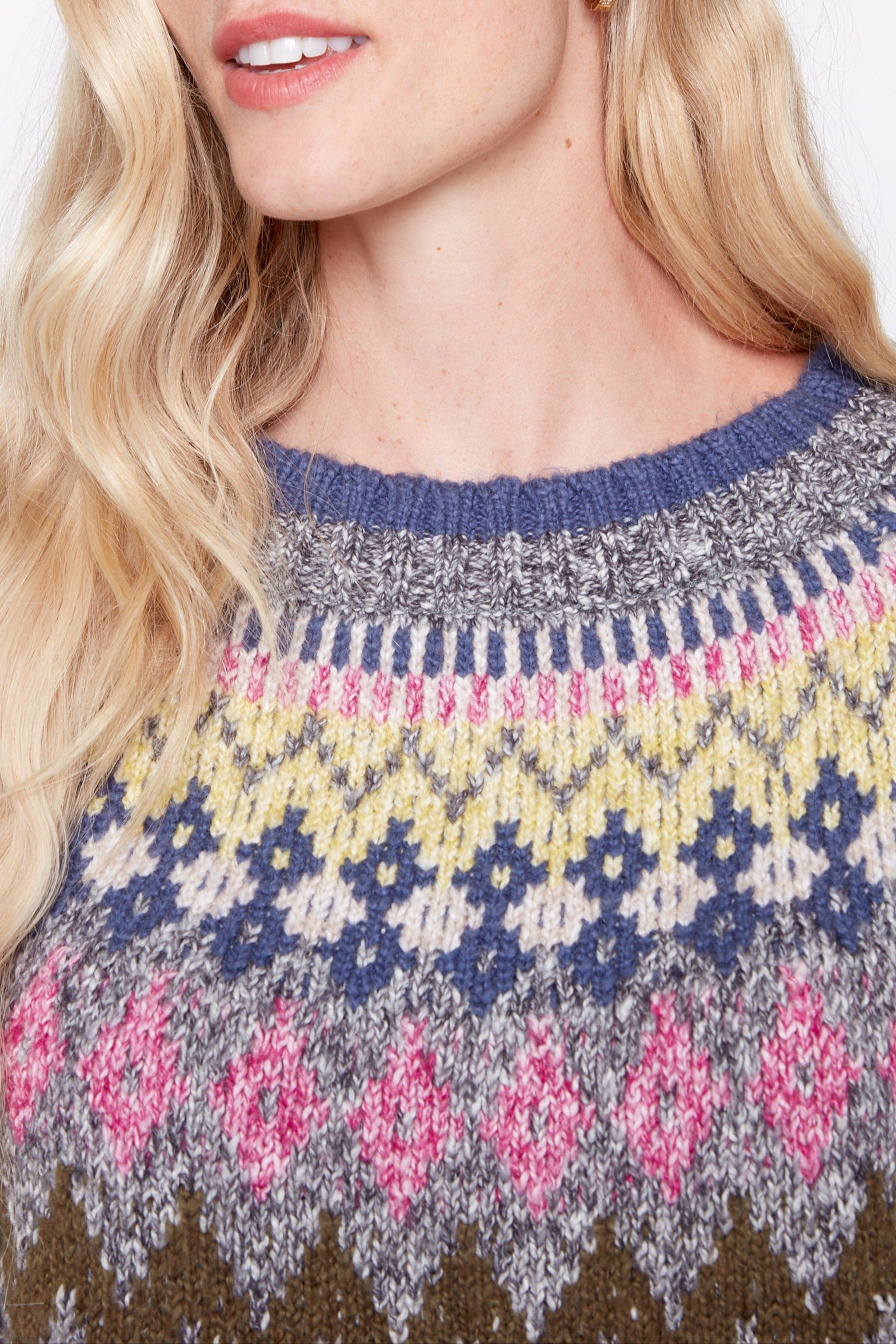 Woman wearing a colorful patterned sweater on a white background
